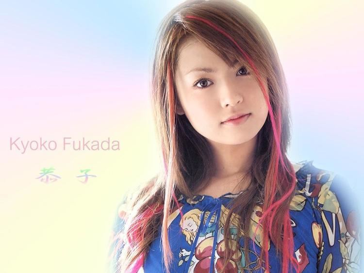 Kyoko Fukada's name and its translation to Japanese symbols (left). Kyoko Fukada with an innocent face and red highlight on her hair while wearing a blue blouse with a woman print (right).
