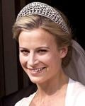 Lady Rose Gilman smiling while wearing a wedding gown, crown, and veil