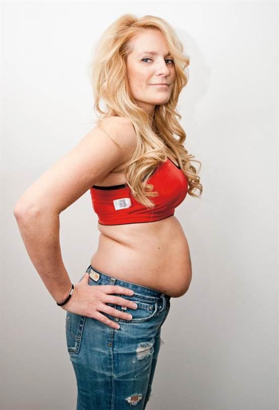 Laila Bagge Wahlgren smiling and standing while wearing a sports bra and pants in white background