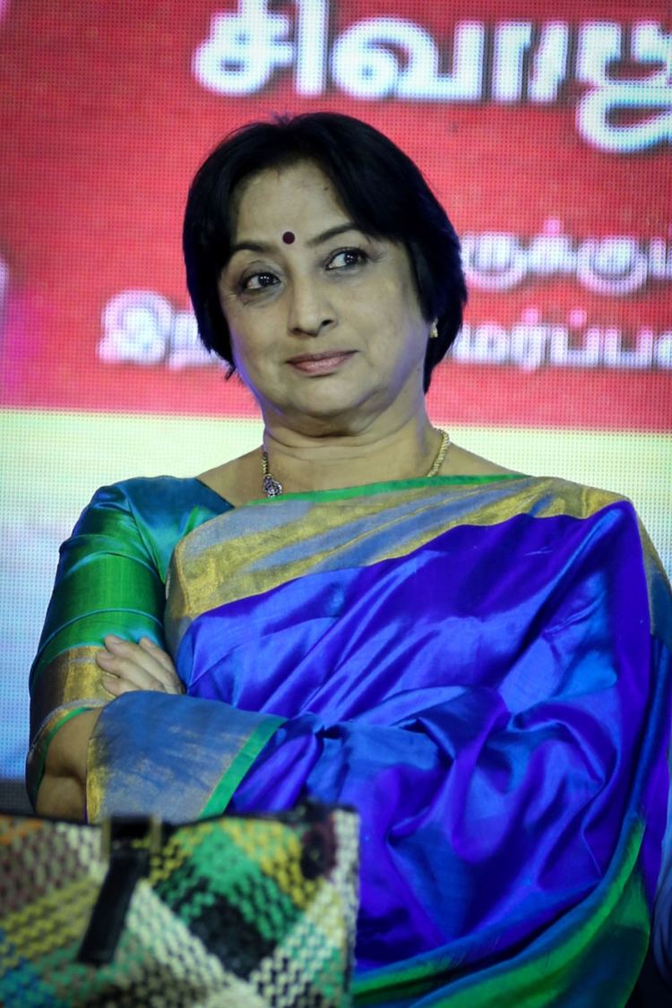 Lakshmi wearing an elegant blue dress with combination of gold and green colors at Naan Suvasikkum Sivaji Book Launch