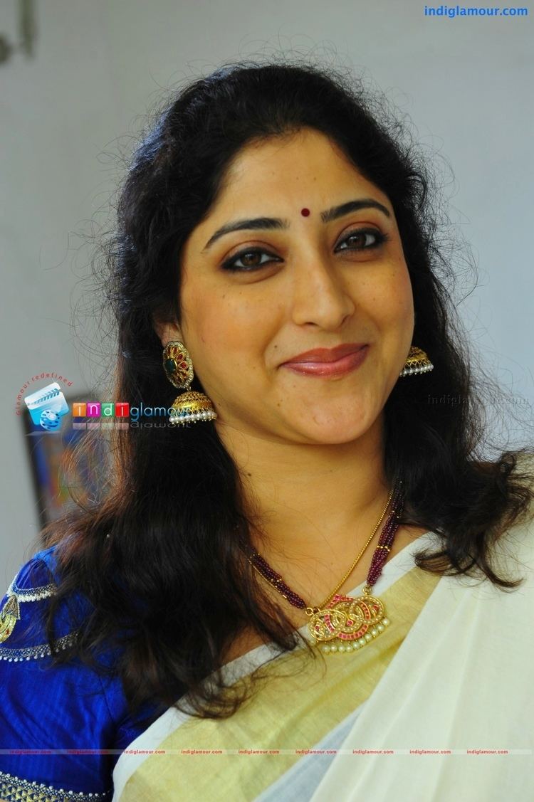 Lakshmi Gopalaswamy wearing jewelries and blue beaded dress with touch of color yellow and cream