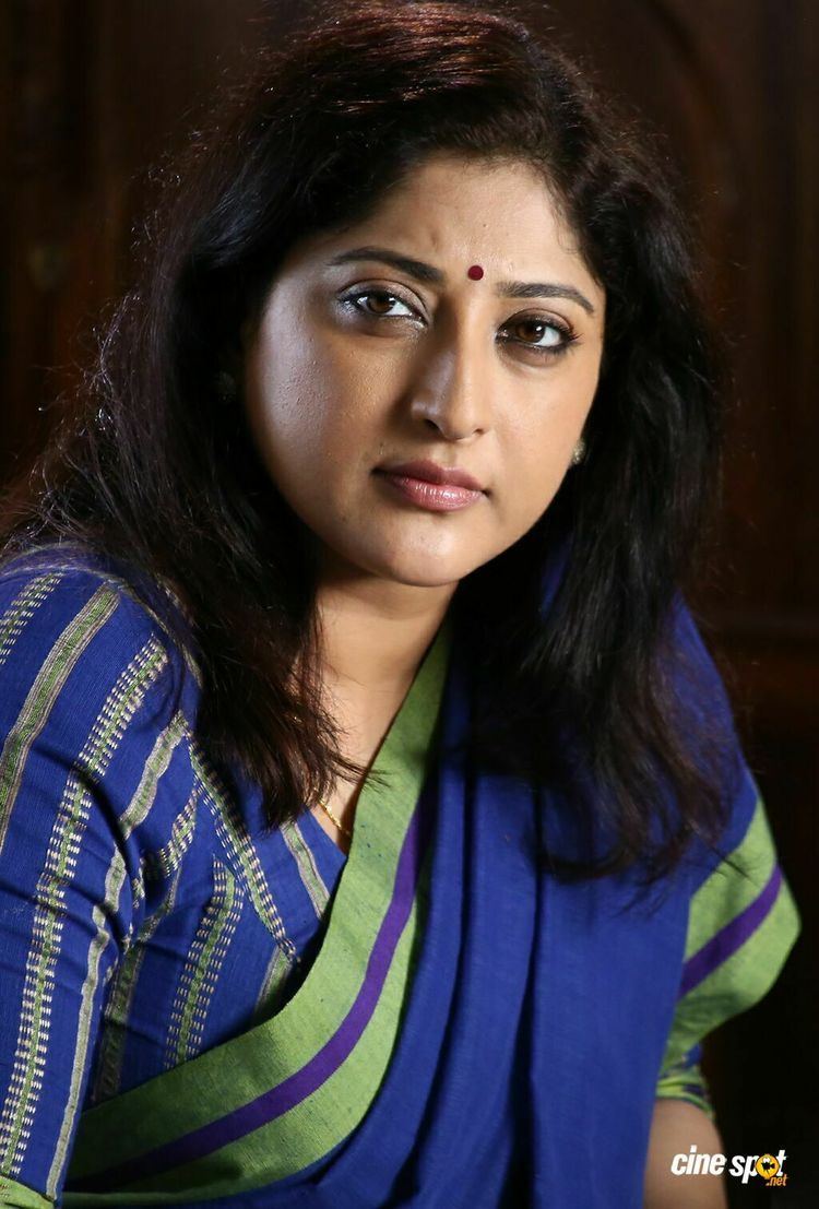 Lakshmi Gopalaswamy's serious face while wearing blue and green dress