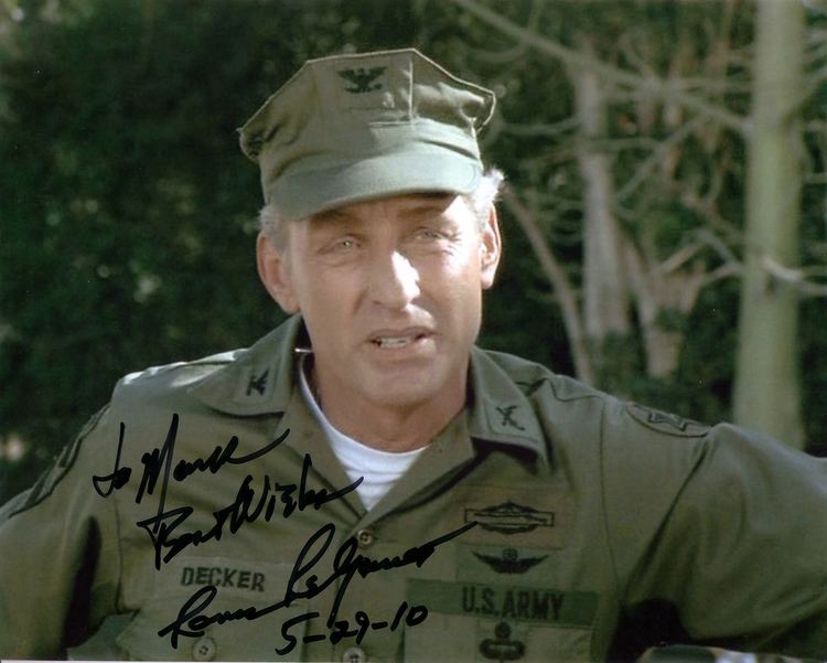 Lance LeGault wearing an army uniform and a signature on the bottom left