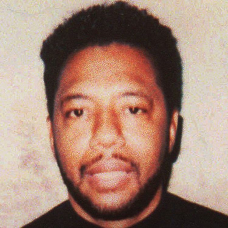 Larry Hoover smiling while wearing a black t-shirt