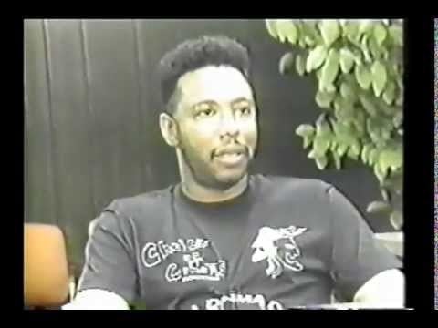 Larry Hoover looking at something while wearing a black printed t-shirt