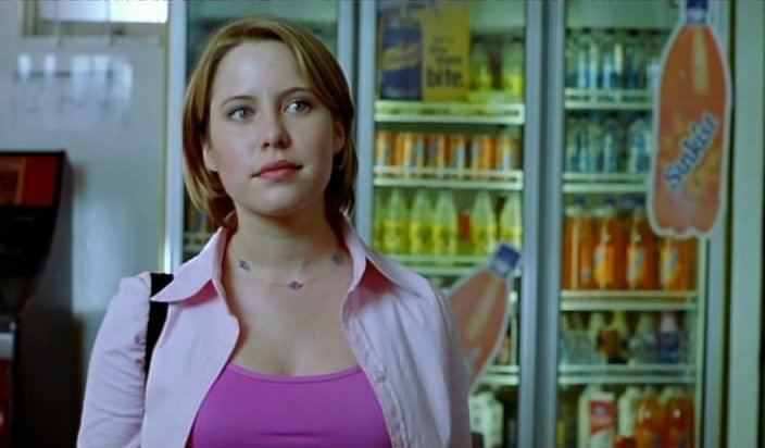 Lauren Hewett as Bronwyn McChristie wearing a pink blouse and shirt in a scene from the Horror Movie 'Cubbyhouse' (2001)