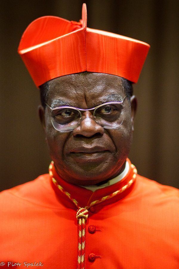 Laurent Monsengwo Pasinya wearing eyeglasses, red cassock and red mitre