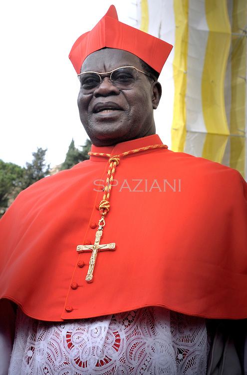 Laurent Monsengwo Pasinya smiling while wearing eyeglasses, cross necklace, red cassock and red mitre
