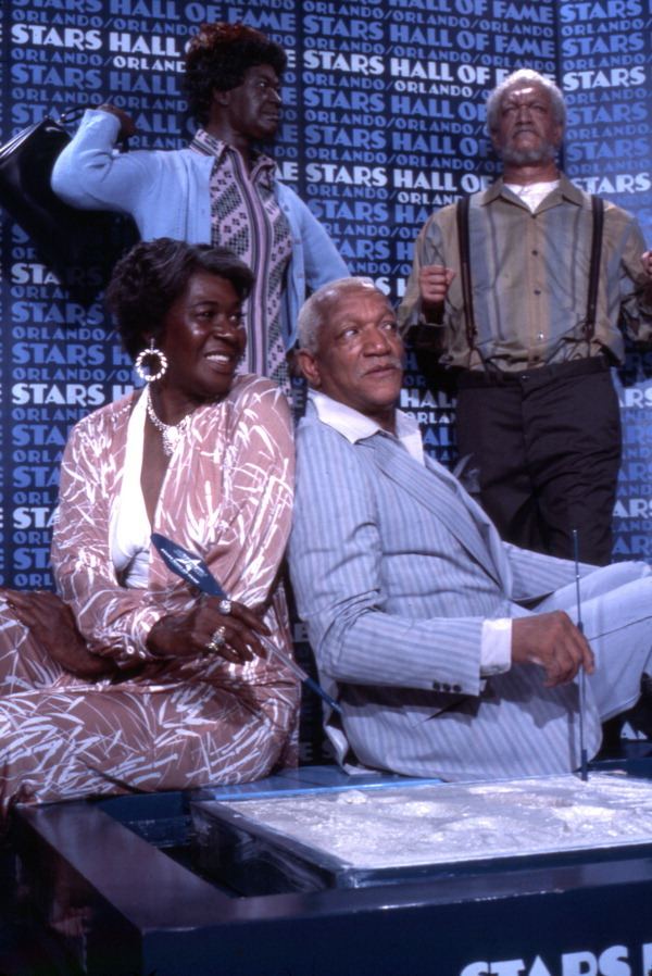 Actor Redd Foxx and actress LaWanda Page sitting with wax statues on display at the Stars Hall of Fame attraction in Orlando