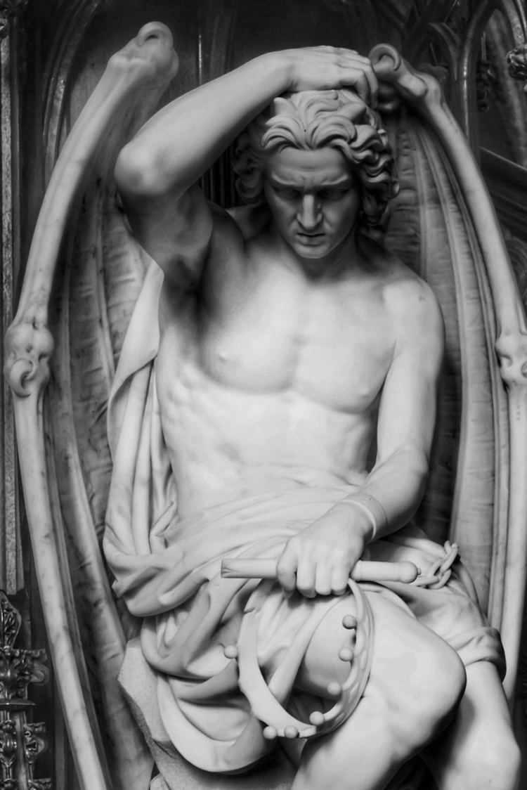 A sculpture of the Fallen Angel Lucifer (Le genie du mal) by the sculptor Guillaume Geefs (Cathedral of St. Paul, Liege, Belgium). Lucifer is clutching his head.