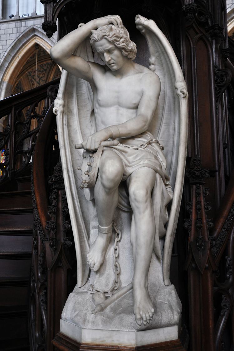 A sculpture of the Fallen Angel Lucifer (Le genie du mal) by the sculptor Guillaume Geefs (Cathedral of St. Paul, Liege, Belgium). Lucifer is clutching his head with a chain on his feet.