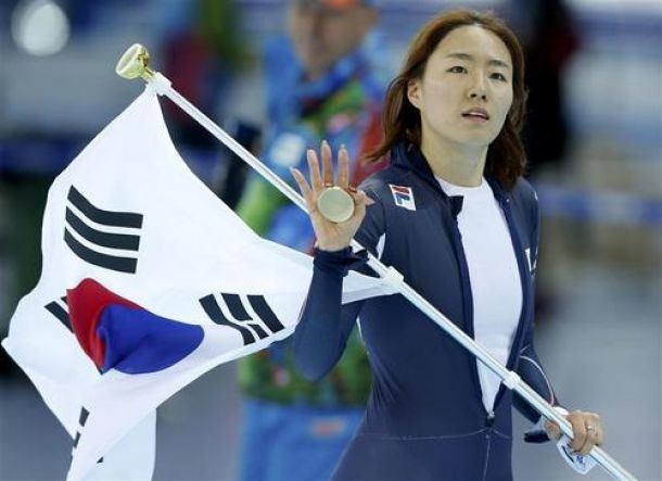 Lee Sang hwa holding the Korean national flag as she celebrates after winning a gold medal in the women's speed skating 500-meter event at the Adler Arena Skating Center in Sochi, Russia