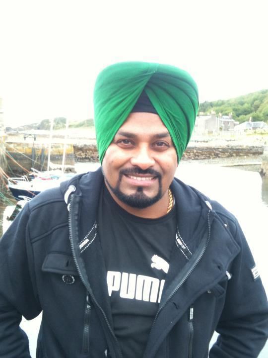 Lehmber Hussainpuri standing outdoor wearing a black shirt and a black jacket