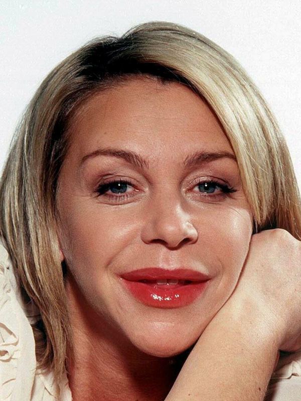 Leslie Ash smiles in a white background