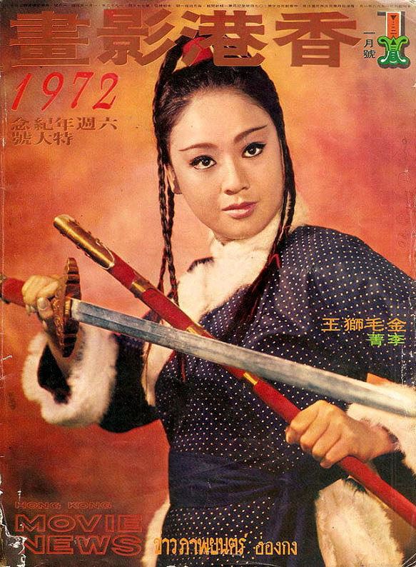 Li Ching with a tight-lipped smile while holding a sword and wearing a white and blue polka dot dress