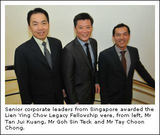 Mr. Tan Jul Kuang, Mr. Goh Sin Teck, and Mr. Tay Choon Chong smiling together while wearing a black coat, long sleeves, and necktie