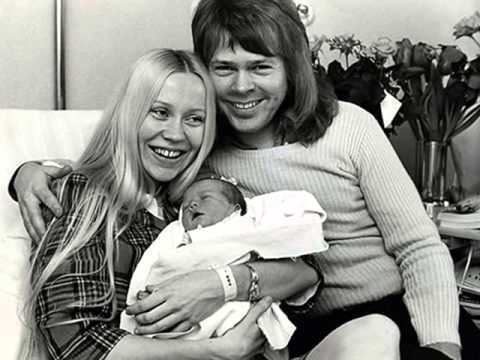 Agnetha Faltskog smiling with Bjorn Ulvaeus while carrying their newborn daughter Linda