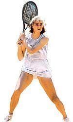 Lisa Bonder holding her racket while wearing striped dress