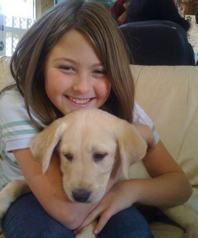 Lisa Bonder's Daughter Kira Kerkorian smiling while hugging his dog