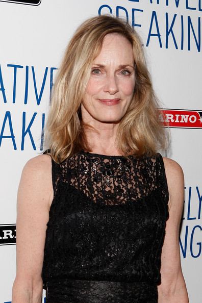 Lisa Emery smiling during the after-party for the Broadway production of 'Relatively Speaking' at the Bryant Park Grill New York City, with blonde shoulder-length wavy hair, while wearing a black lace sleeveless dress