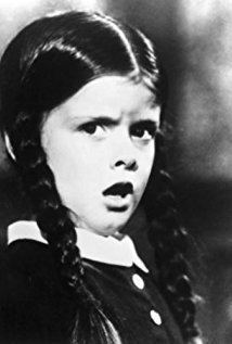 Lisa Loring looking surprised with her braided hair as Wednesday on the 1964 TV series "The Addams Family"