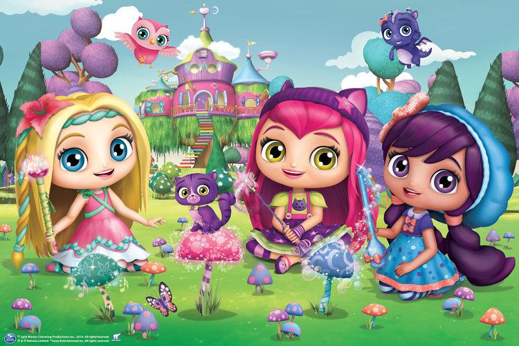 The Little Charmers characters Posie, Hazel Charming and Lavender sitting outside a garden near a castle.