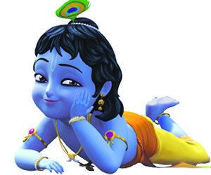 Little Krishna smiling while lying on the ground and wearing yellow pants, earrings, necklace, armlet, and bracelet