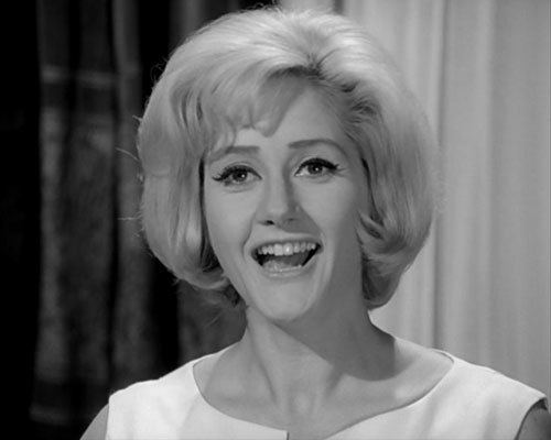 Liz Fraser smiling, with blonde hair and wearing a sleeveless top.