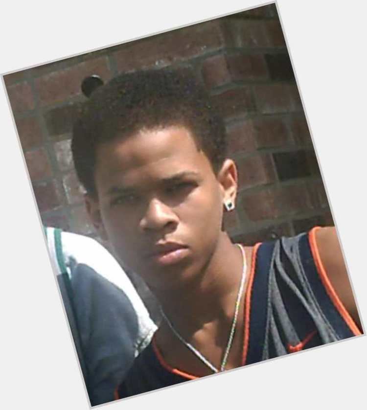 Lloyd Avery II at a young age, wearing earrings, a necklace, and a jersey.