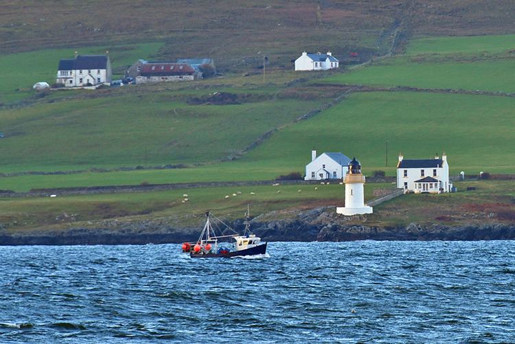 Loch Indaal Fishing boat passing Loch Indaal lighthouse Isle of Islay Islay