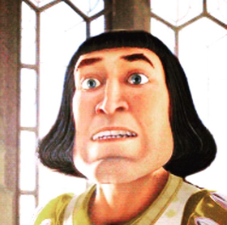 Lord Farquaad talking to someone with his eyes wide open and wearing a white and yellow dress