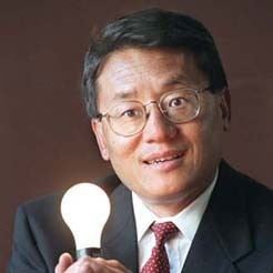 Lou Pai holding a lighted bulb