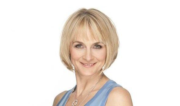 Louise Minchin smiling while wearing a blue sleeveless top
