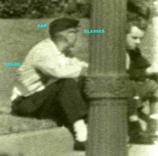 “Dark Complected Man” and “Umbrella Man” are sitting on the floor in Dealey Plaza