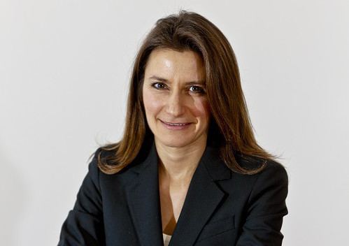 Lucy Frazer wearing a coat in white background
