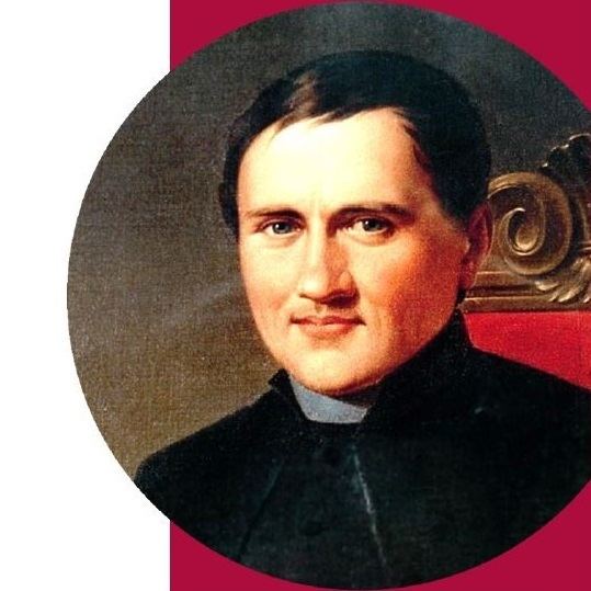 Luigi Caburlotto posing in a portrait sitting in a red chair and wearing black cassock (clergy garments).
