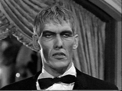 Lurch (The Addams Family) looking annoyed while inside a room