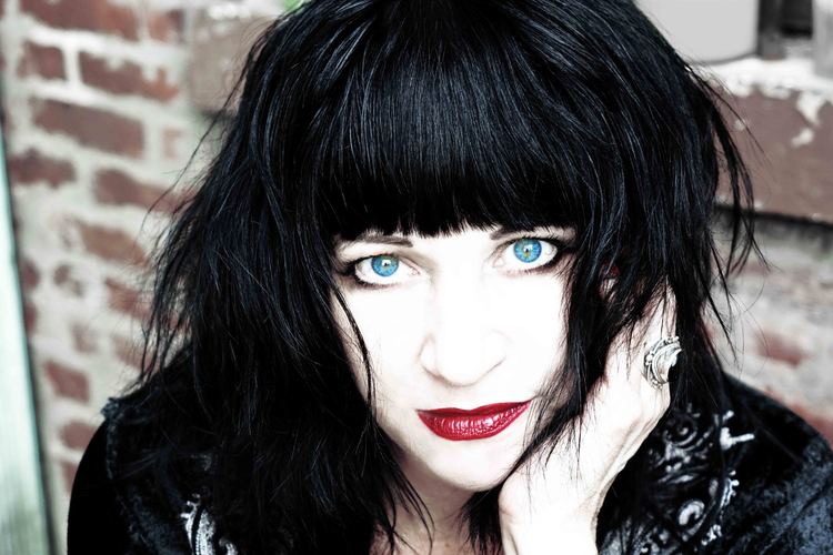 Lydia Lunch wearing a black shirt and a ring