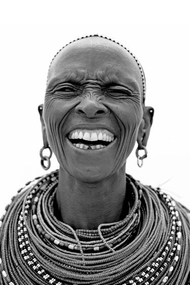 Portrait of a Samburu Warrior tribe while laughing captured by Lyle Owerko.