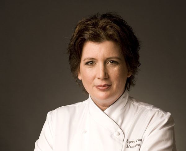 Lynn Crawford smiling and wearing white chef's uniform
