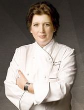 Lynn Crawford's arms crossed while wearing white chef's uniform