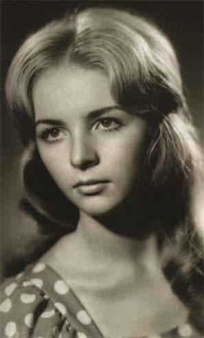 Lyudmila Putina looking at the left side with a serious face and wavy hair while wearing a polka dot blouse