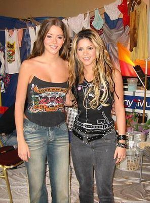 Marion Raven and Marit Larsen of the M2M band are both smiling and Marion is wearing a black tube top while Marit is wearing a black sleeveless top