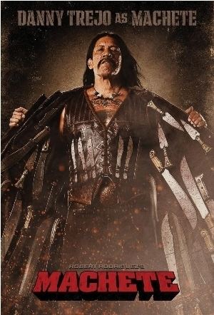 Danny Trejo as Machete, wearing a coat with swords, brown vest, and pants, in the 2010 American exploitation action film, Machete