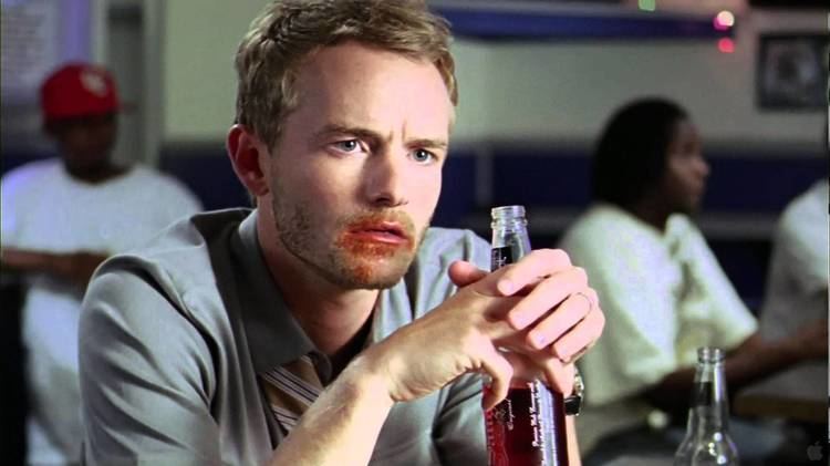 Christopher Masterson drinking a beer while wearing gray long sleeves in a movie scene from the 2009 film Made for Each Other