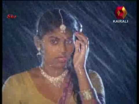 Madhuri wearing a yellow dress, jewelries & headpiece while dancing in the rain
