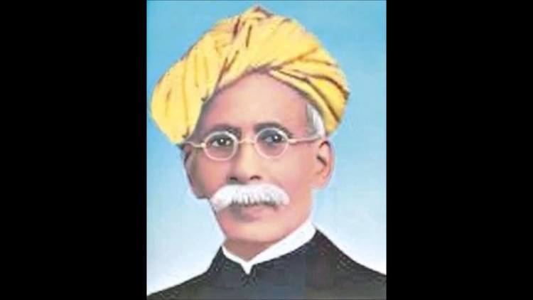 Madhusudan Das with mustache while wearing a yellow turban, eyeglasses, and black long sleeves