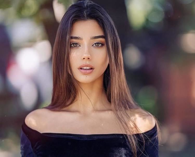 Maja Strojek posing with her mouth half-open while wearing a black blouse