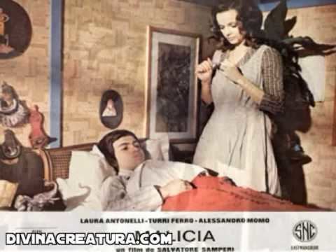 Laura Antonelli taking care of Alessandro Momo while being sick in a movie scene from Malicious (1973 film)