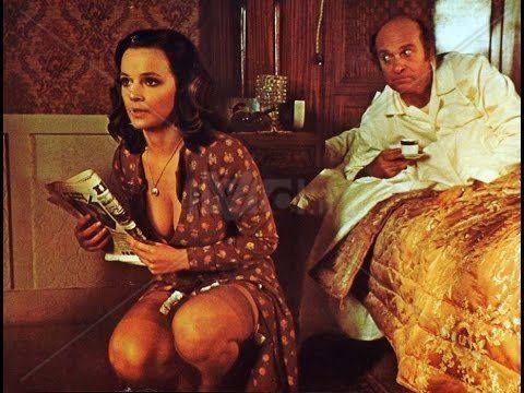 Laura Antonelli and Turi Ferro inside the bedroom in a movie scene from Malicious, 1973